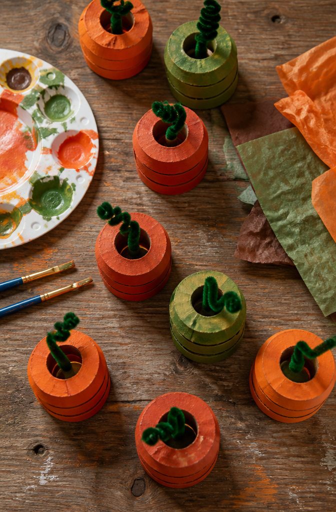 20 Fall Pumpkin Crafts to Make for Your Home in 2026 9 Pumpkins made from cut toilet paper rolls and pipe cleaners.