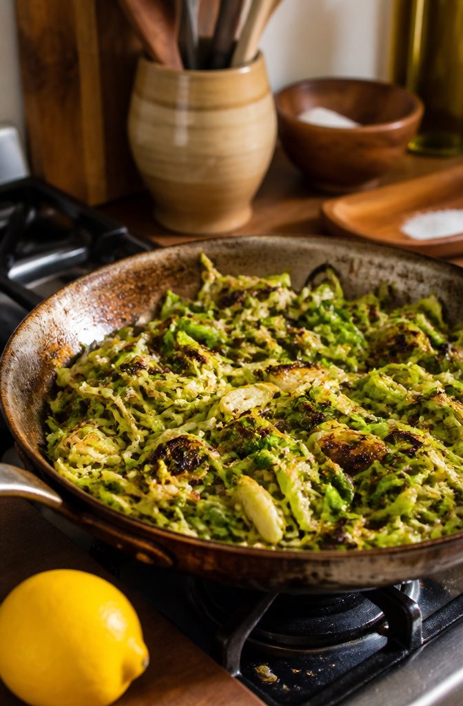 A pan of hashed Brussels sprouts with a mix of textures and colors.