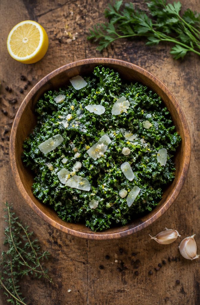 A bowl of lemon-garlic kale salad with bright green leaves.