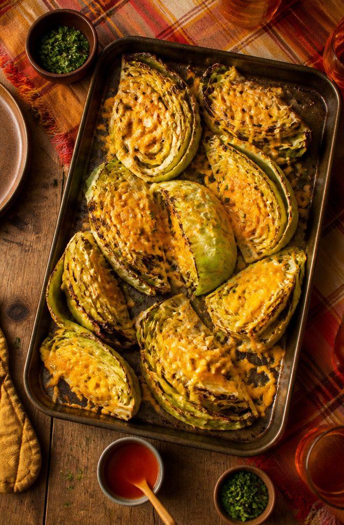 20 Thanksgiving Dinner Main Dishes for 2026 13 Roasted cabbage wedges with melted cheese on top.