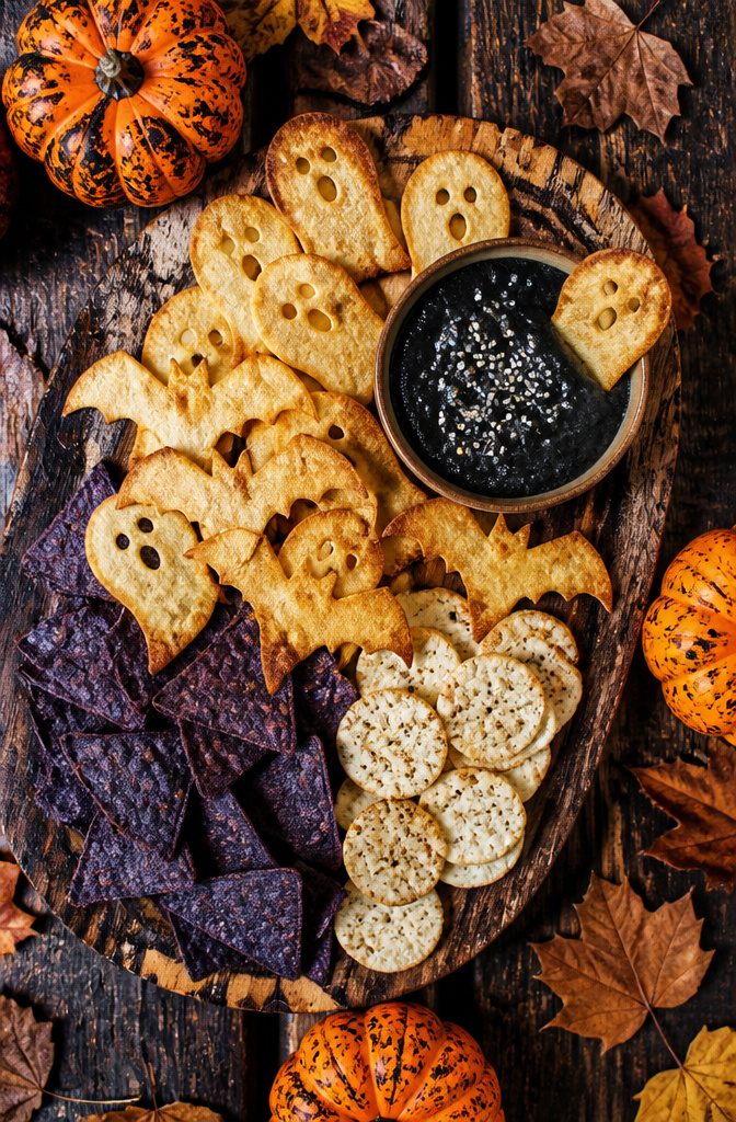 Chips shaped like ghosts and bats, served on a platter.